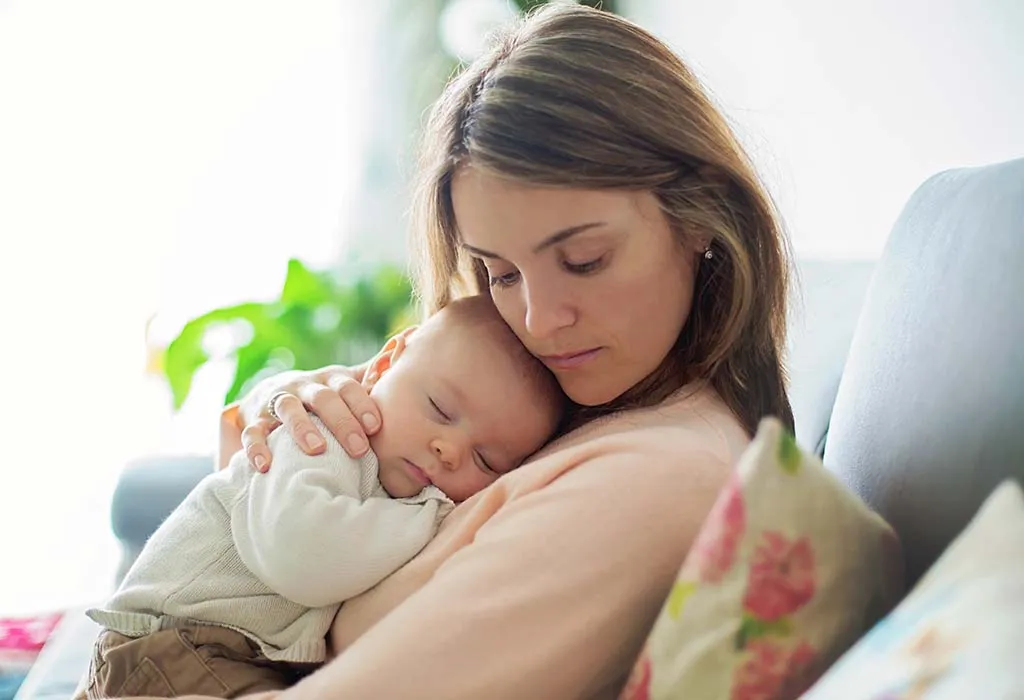 A mother lovingly cradling her newborn baby, symbolizing the compassionate care provided by Dr. Archana Sisodia, a female gynecologist and pregnancy specialist in Ahmedabad, who supports women through their pregnancy journey.